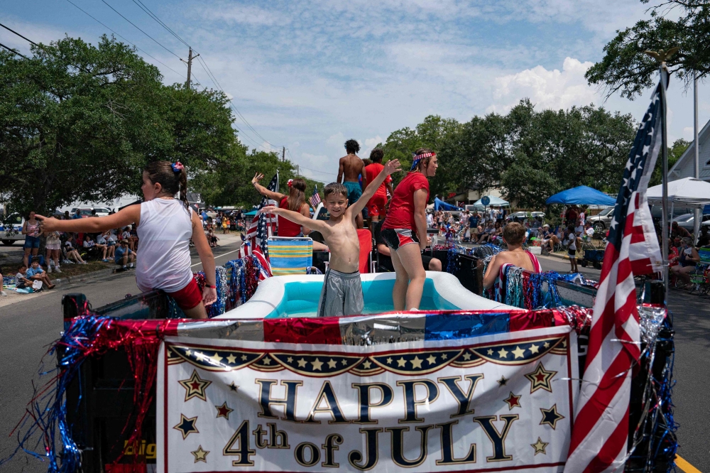 Residents participate in the annual Independence Day Parade on July 4, 2023 in Southport, North Carolina. (Photo by Allison Joyce / Getty Images via AFP)

