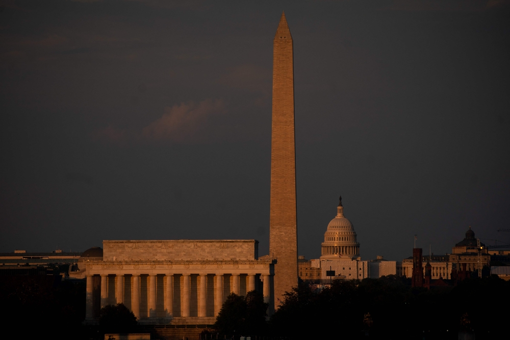 The US Capitol and washington Monument are seen ahead of the Independence Day fireworks display along the National Mall in washington, DC, on July 4, 2023. (Photo by Stefani Reynolds / AFP)
