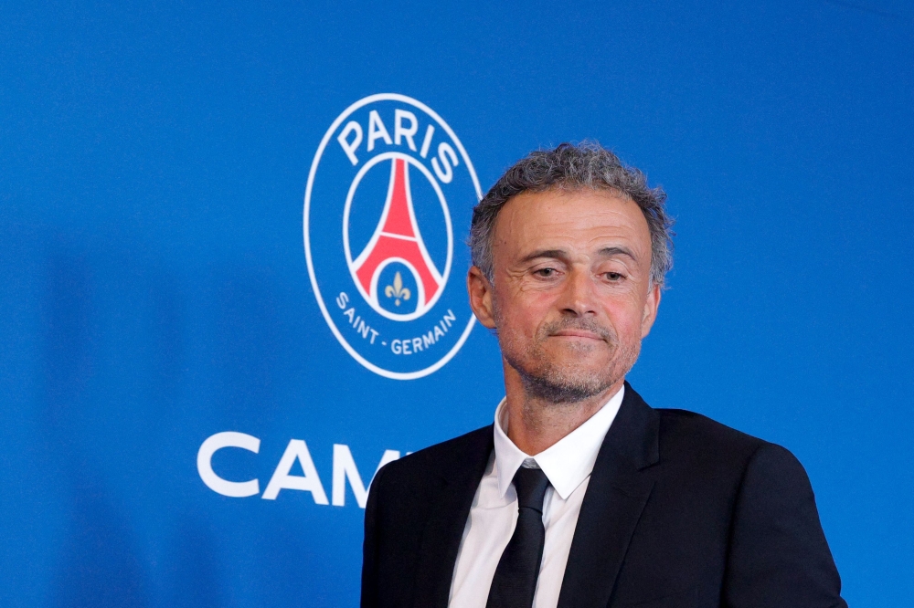 Paris Saint-Germain's newly appointed Spanish head coach Luis Enrique leaves at the end of a press conference to announce the presentation of the new coach, at the new 'campus' of French L1 Paris Saint-Germain (PSG) football club at Poissy, west of Paris on July 5, 2023. (Photo by Geoffroy Van der Hasselt / AFP)

