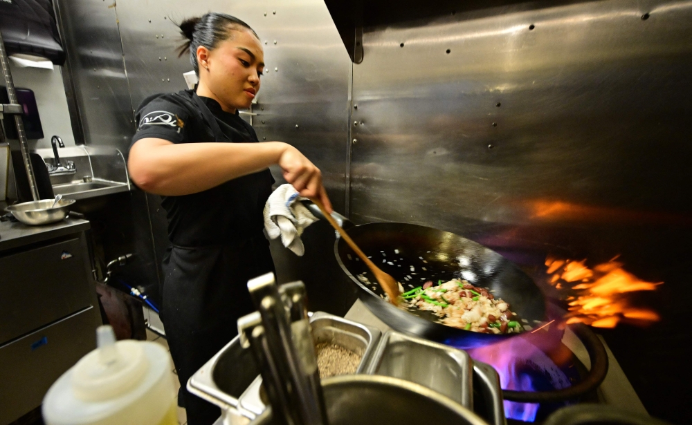 Chef Tue Nguyen cooks her Didi Fried Rice in the kitchen of her soon-to-open first restaurant, called Di Di (Let's Go! in Vietnamese), in West Hollywood, California. (Photo by Frederic J. Brown / AFP)