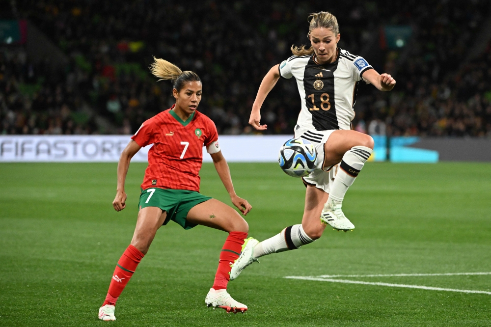(Files) Germany's midfielder #18 Melanie Leupolz (R) controls the ball next to Morocco's forward #07 Ghizlane Chebbak (L) in Melbourne on July 24, 2023. (Photo by William West / AFP)