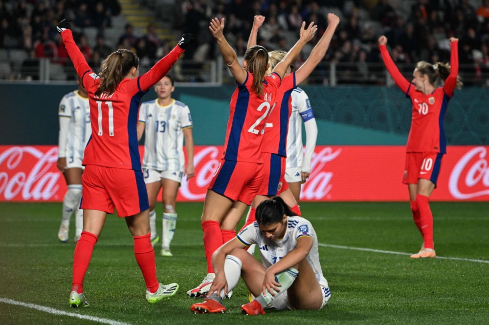 Norway players celebrate their fourth goal scored by Philippines' defender #17 Alicia Barker (bottom) during the Australia and New Zealand 2023 Women's World Cup Group A football match between Norway and the Philippines at Eden Park in Auckland on July 30, 2023. (Photo by Saeed Khan / AFP)