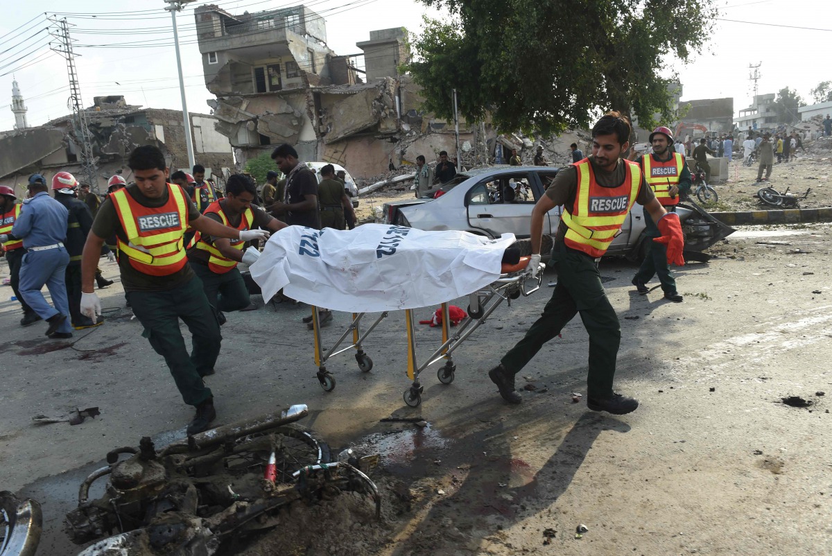 File photo of Pakistani rescue workers move the body of a victim at the site of an explosion in Lahore on July 24, 2017. (AFP / ARIF ALI)