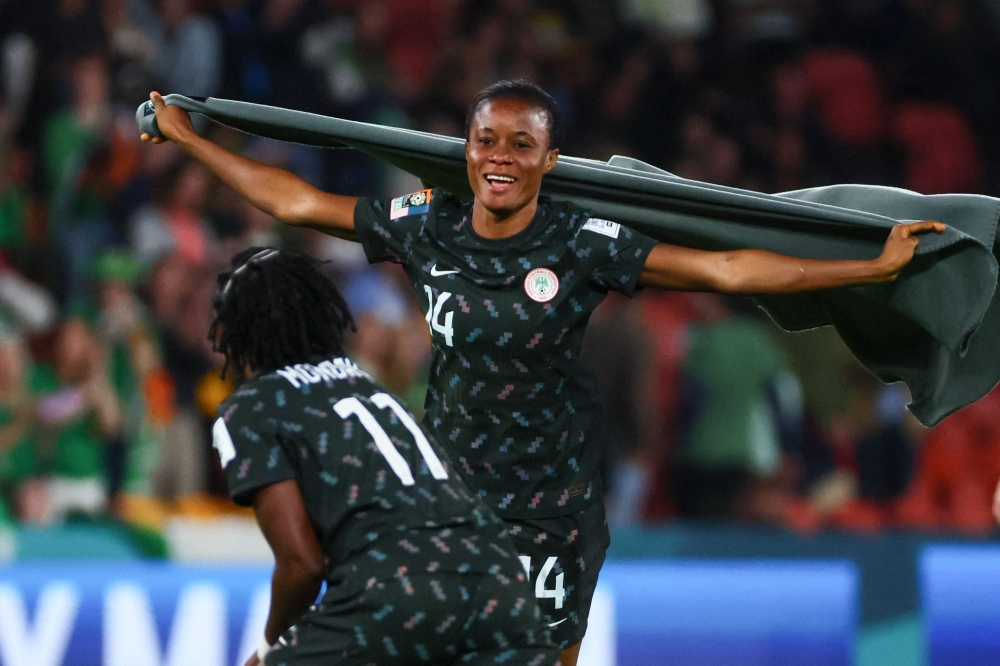 Nigeria's defender #14 Oluwatosin Demehin (R) celebrates with Nigeria's forward #11 Gift Monday after the end of the Australia and New Zealand 2023 Women's World Cup Group B football match between Ireland and Nigeria at Brisbane Stadium in Brisbane on July 31, 2023. (Photo by Patrick Hamilton / AFP)