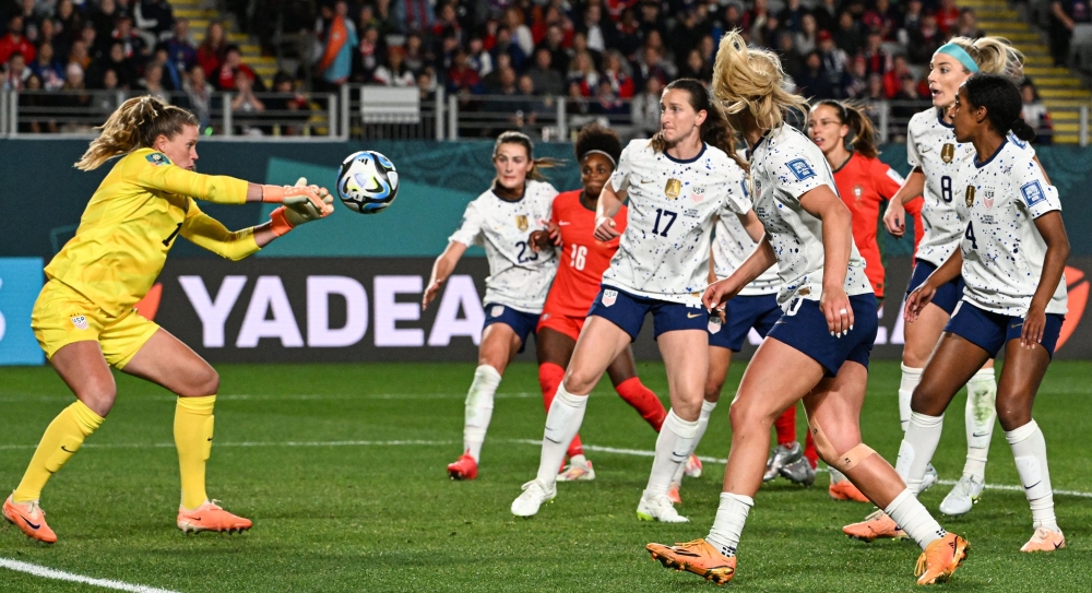 USA's goalkeeper #01 Alyssa Naeher (L) makes a save during the Australia and New Zealand 2023 Women's World Cup Group E football match between Portugal and the United States at Eden Park in Auckland on August 1, 2023. (Photo by Saeed Khan / AFP)