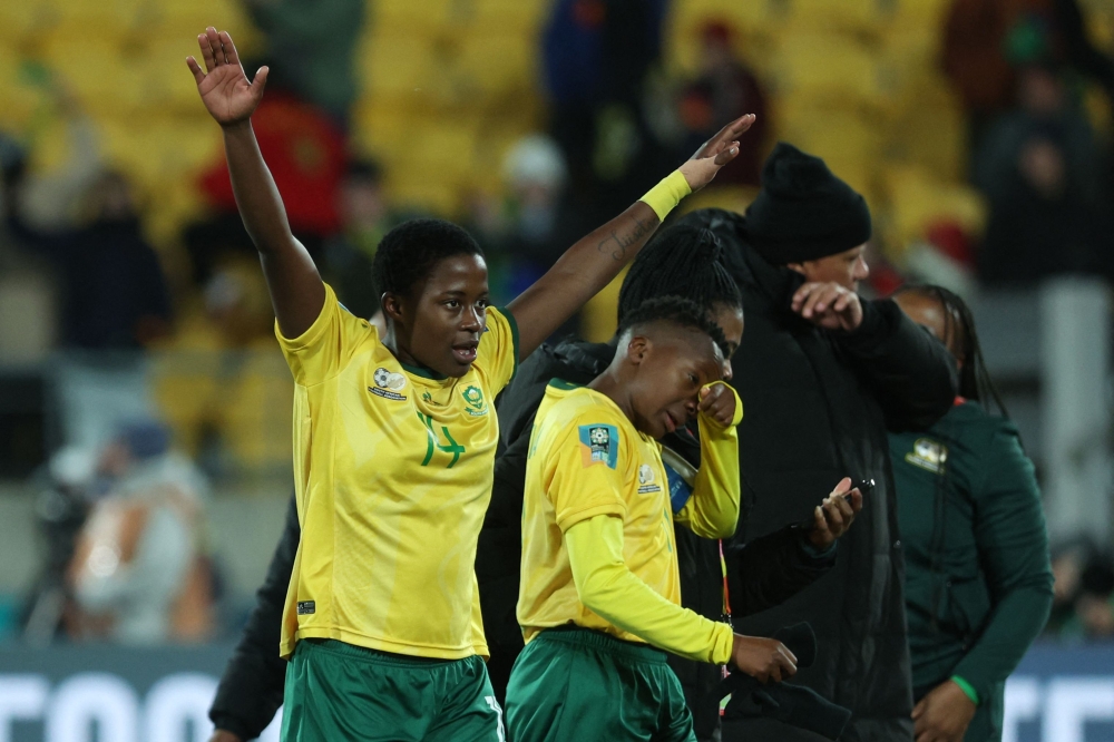 South Africa's defender #14 Tiisetso Makhubela (L) celebrates with teammates their win at the end of match between South Africa and Italy at Wellington Stadium in Wellington on August 2, 2023. (Photo by Marty Melville / AFP)