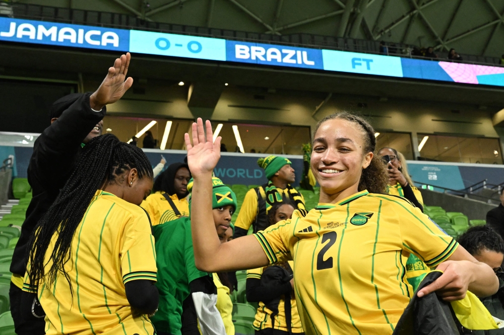 Jamaica's midfielder #02 Solai Washington celebrates her team qualifying for the last 16 following the Australia and New Zealand 2023 Women's World Cup Group F football match between Jamaica and Brazil at Melbourne Rectangular Stadium, also known as AAMI Park, in Melbourne on August 2, 2023. (Photo by WILLIAM WEST / AFP)
