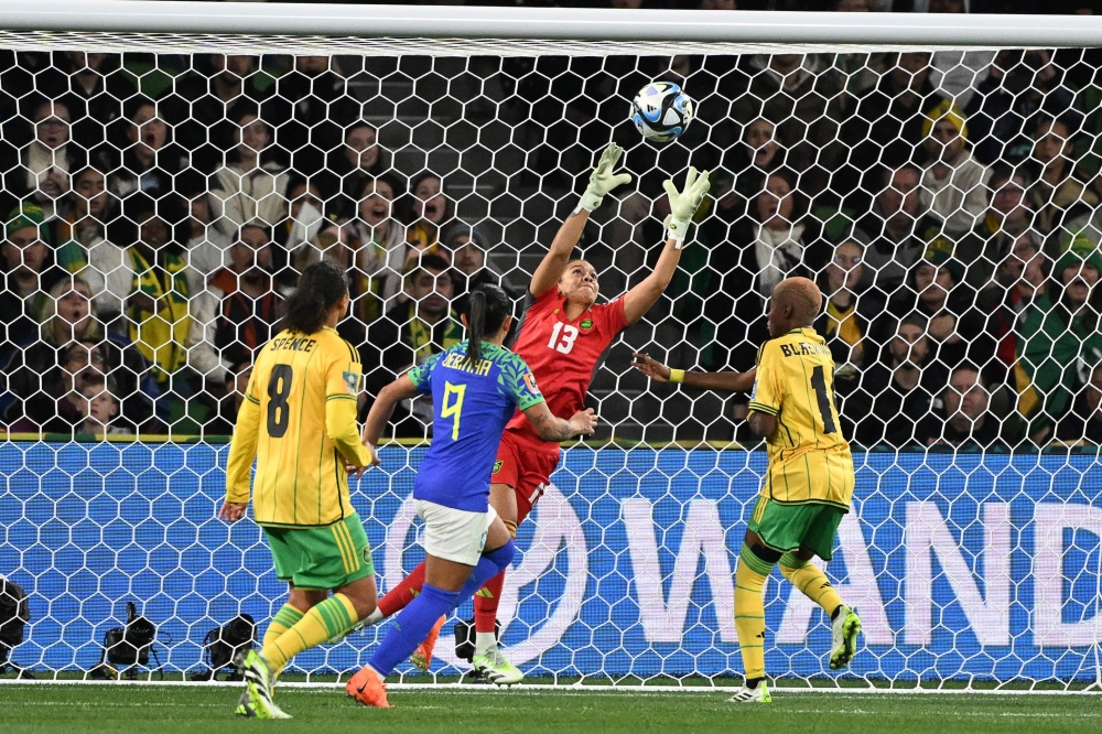 Jamaica's goalkeeper #13 Rebecca Spencer makes a save in front of Jamaica's midfielder #08 Drew Spence (L), Brazil's forward #09 Debinha and Jamaica's defender #14 Deneisha Blackwood during the Australia and New Zealand 2023 Women's World Cup Group F football match between Jamaica and Brazil at Melbourne Rectangular Stadium, also known as AAMI Park, in Melbourne on August 2, 2023. Photo by WILLIAM WEST / AFP