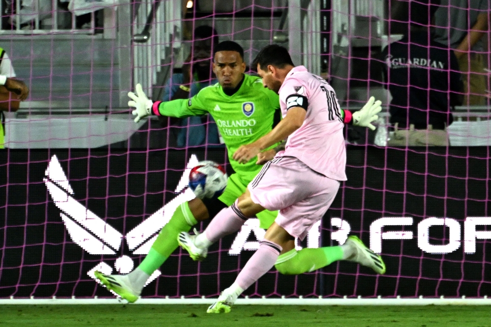 Inter Miami's Argentine forward Lionel Messi (R) scores his team's first goal during the round of 32 Leagues Cup football match between Inter Miami CF and Orlando City SC at DRV PNK Stadium in Fort Lauderdale, Florida, on August 2, 2023. (Photo by Chandan Khanna / AFP)