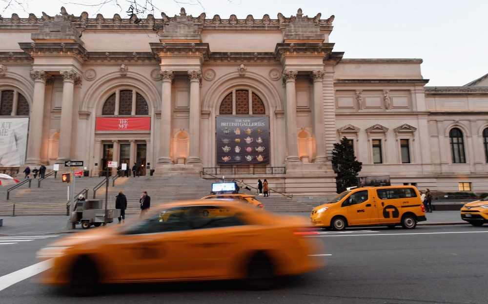 A yellow cab drives by the Metropolitan Museum of Art on January 7, 2021 in New York City. Photo by Angela Weiss / AFP