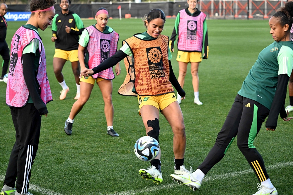 Jamaica's Kaylssa Van Zanten (C) and teammates take part in a training session in Melbourne on August 7, 2023, on the eve of the Women's World Cup football match between Colombia and Jamaica. Photo by William WEST / AFP