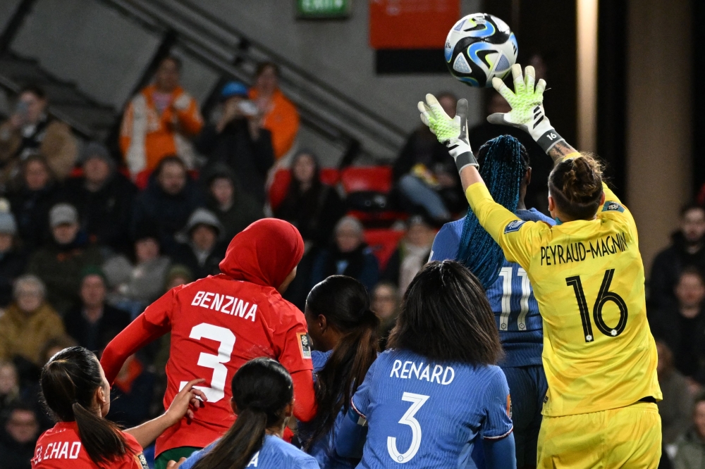 France's goalkeeper #16 Pauline Peyraud-Magnin (R) makes a save during the match between France and Morocco on August 8, 2023. (Photo by Brenton Edwards / AFP)