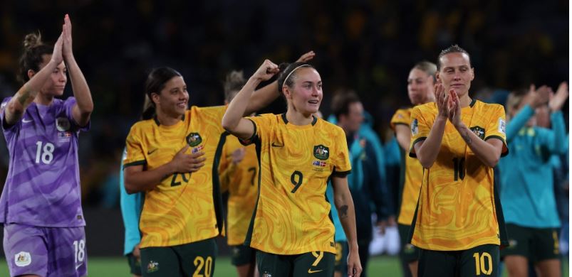 Australia's forward #09 Caitlin Foord (C) celebrates with teammates at the end of their match with Denmark at Stadium Australia in Sydney on August 7, 2023. (Photo by Steve Christo / AFP)


