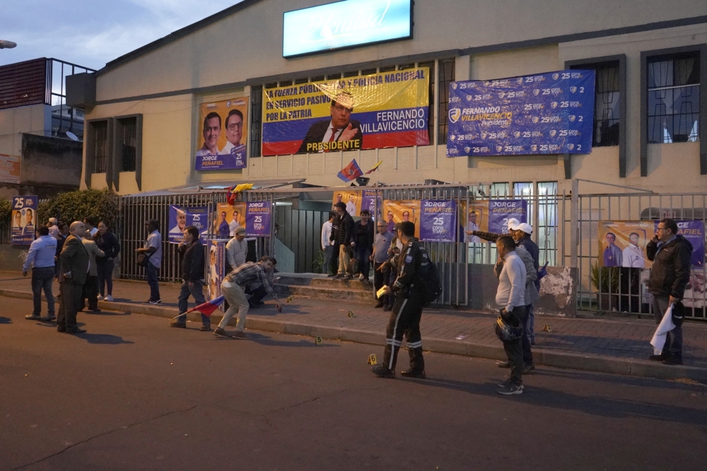 People gather outside the building where Ecuadorian presidential cadidate Fernando Villavicencio held a rally after shots were fired in Quito, on August 9, 2023. (Photo by AFP)
