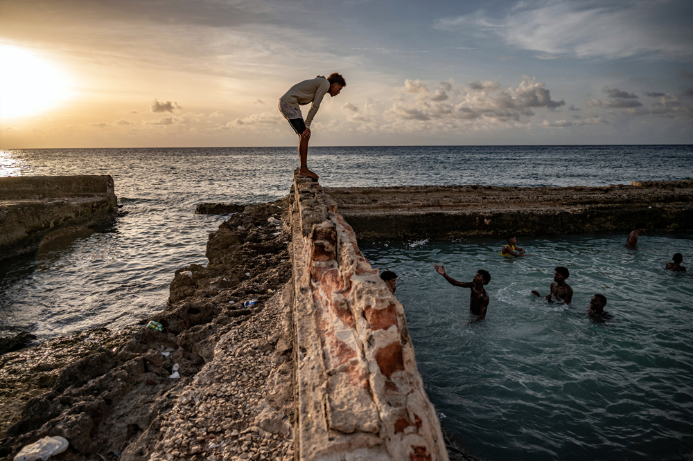 Cubans swim in a natural swimming pool off the coast of Havana on August 4, 2023. Photo by Yamil LAGE / AFP