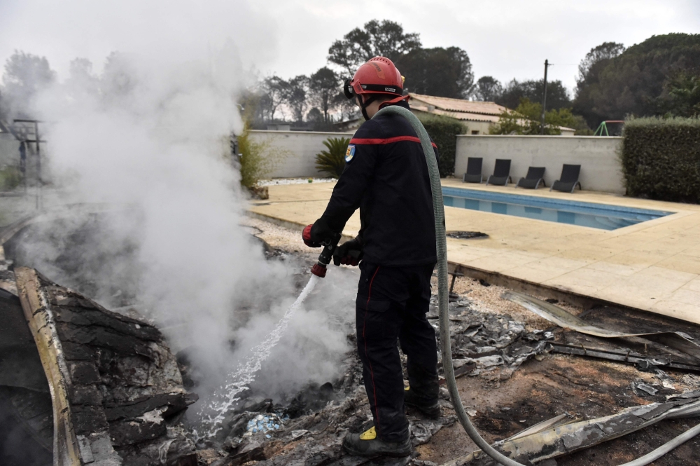 A firefighter puts out fires after the blaze that ravaged the commune of Saint-André, Pyrénées-Orientales, France on August 15, 2023. Photo by RAYMOND ROIG / AFP