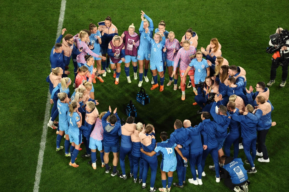 England's team celebrates winning the Australia and New Zealand 2023 Women's World Cup semi-final football match between Australia and England at Stadium Australia in Sydney on August 16, 2023. (Photo by David Gray / AFP)