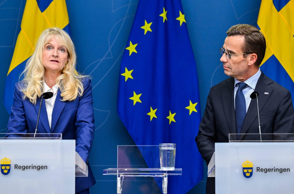 Sweden's Security Police Chief Charlotte von Essen (left) and Sweden's Prime Minister Ulf Kristersson address a press conference as the terror threat level in Sweden was raised to four on a five-point scale in Stockholm on August 17, 2023, following recent Quran burnings. (Photo by Henrik Montgomery / various sources / AFP) 