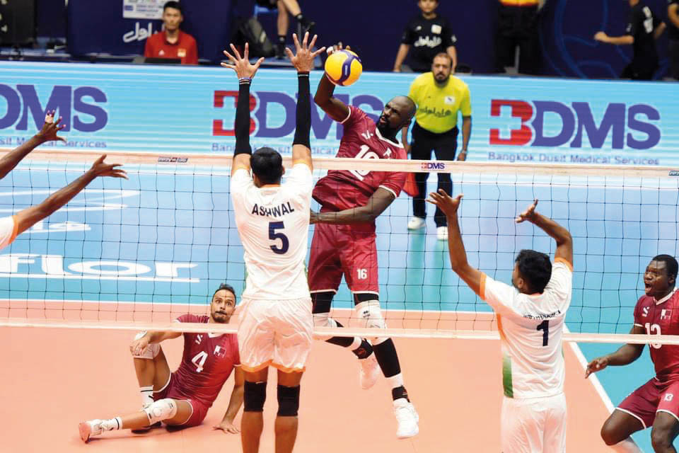 A Qatar player shoots to score against India. 