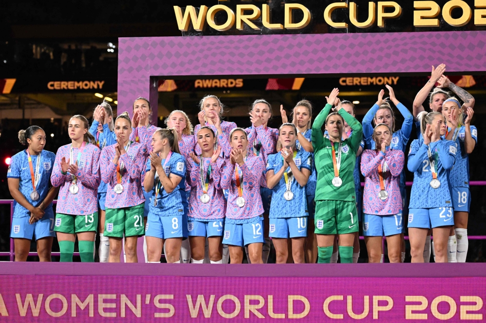 England's players stand on the podium after receiving the runners up medals at the end of the Australia and New Zealand 2023 Women's World Cup final football match between Spain and England at Stadium Australia in Sydney on August 20, 2023. Photo by WILLIAM WEST / AFP