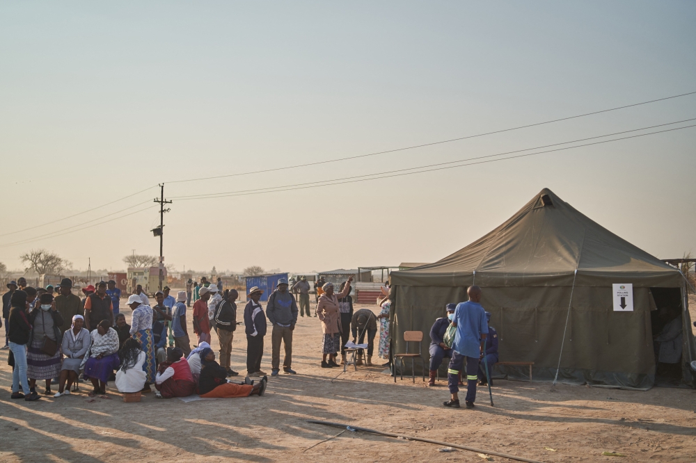 Voters wait to cast their votes next to a polling station during Zimbabwe's presidential and legislative elections in Bulawayo on August 23, 2023. (Photo by Zinyange Auntony / AFP)