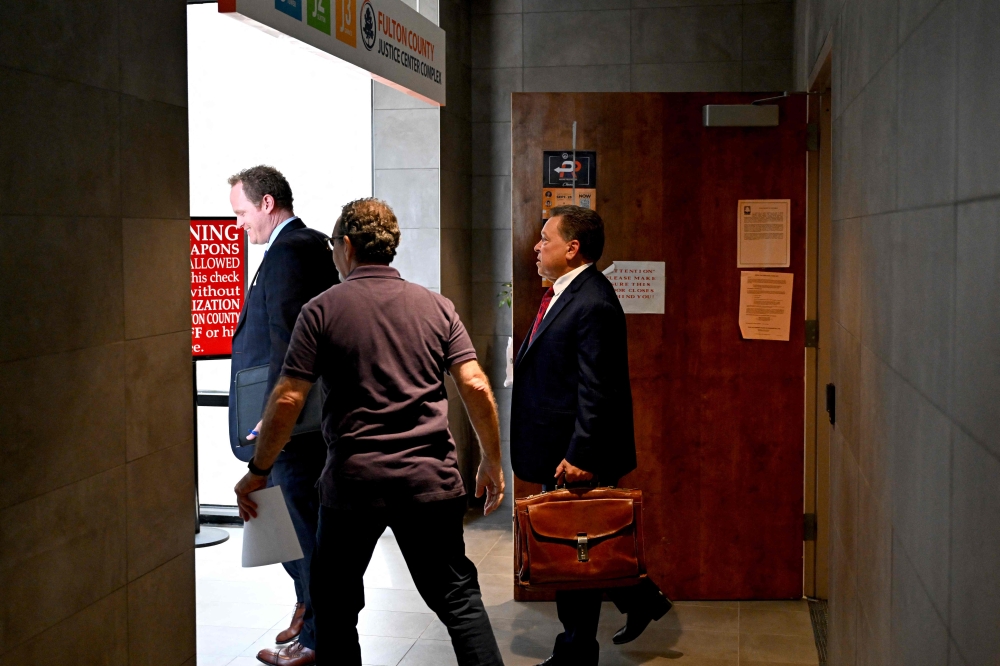 John Esposito (R) and Brian Tevis (L), lawyers of Rudy Giuliani, former attorney to former US President Donald Trump, leave the District Attorney's Office at the Fulton County Government Center in Atlanta, Georgia, on August 23, 2023. (Photo by CHANDAN KHANNA / AFP)
