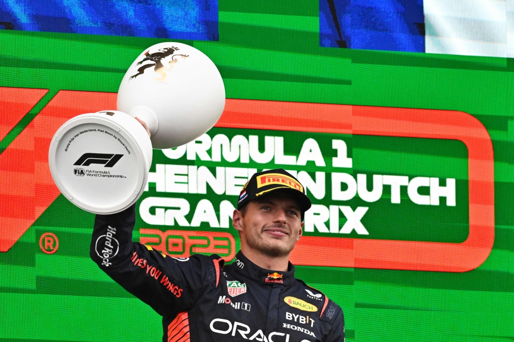 Red Bull Racing's Dutch driver Max Verstappen celebrates with the trophy on the podium after winning the Dutch Formula One Grand Prix race at The Circuit Zandvoort, in Zandvoort on August 27, 2023. (Photo by John Thys / AFP)