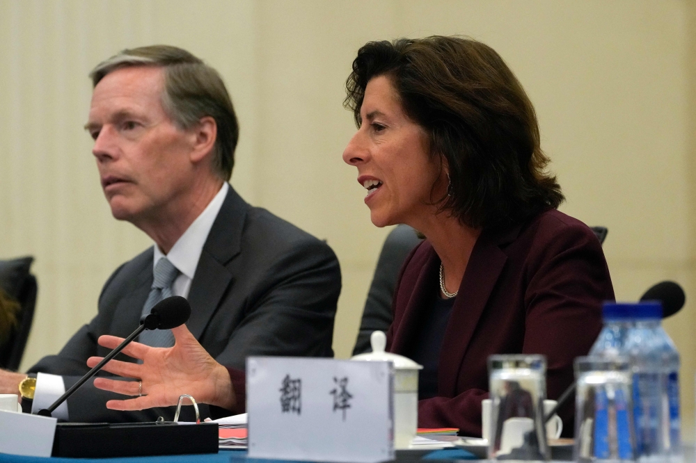 US Commerce Secretary Gina Raimondo (R) speaks next to US Ambassador to China Nick Burns (L) during a meeting with China's Minister of Commerce Wang Wentao on August 28, 2023. (Photo by Andy Wong / Pool / AFP)
