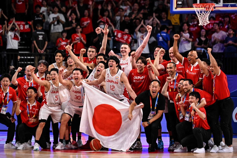 Members of team Japan celebrate the victory after the FIBA Basketball World Cup group O match between Japan and Cape Verde at Okinawa Arena in Okinawa on September 2, 2023. (Photo by Yuichi YAMAZAKI / AFP)
