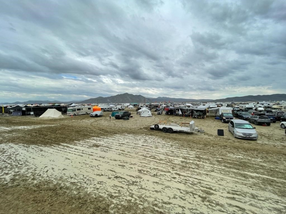 Camps are set on a muddy desert plain on September 2, 2023, after heavy rains turned the annual Burning Man festival site in Nevada's Black Rock desert into a mud pit. (Photo by Julie Jammot / AFP)