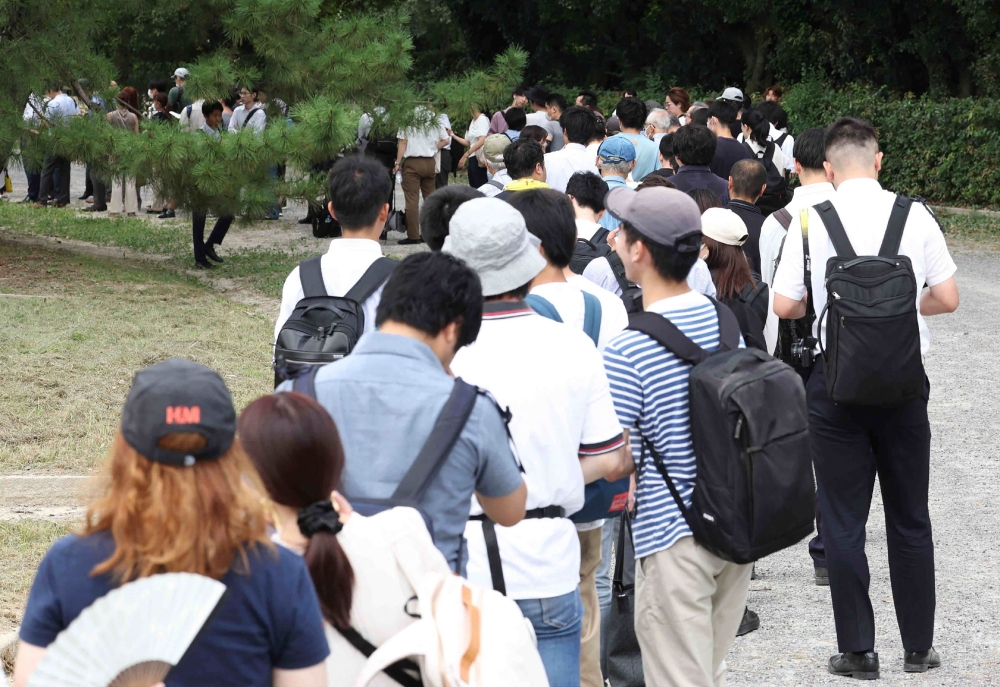 People wait in line for tickets to attend the first trial of Shinji Aoba, the defendant in the Kyoto Animation arson murder case, in Kyoto on September 5, 2023. Photo by JIJI Press / AFP