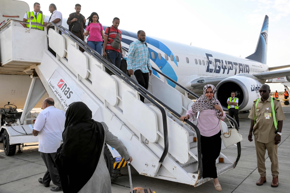 Passengers disembark off an EgyptAir Boeing 737 aircraft upon landing for the first time at Port Sudan International Airport on September 5, 2023 upon the inauguration of a new international flight route between Cairo and Port Sudan. (Photo by AFP)