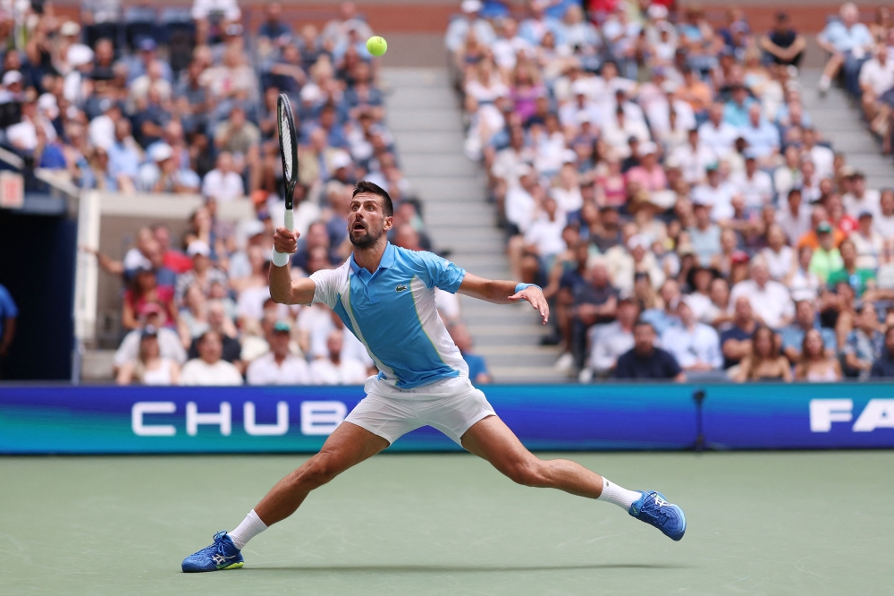 Novak Djokovic of Serbia hits a forehand during his Men's Singles Quarterfinal match against Taylor Fritz of the United States. Clive Brunskill/Getty Images/AFP 