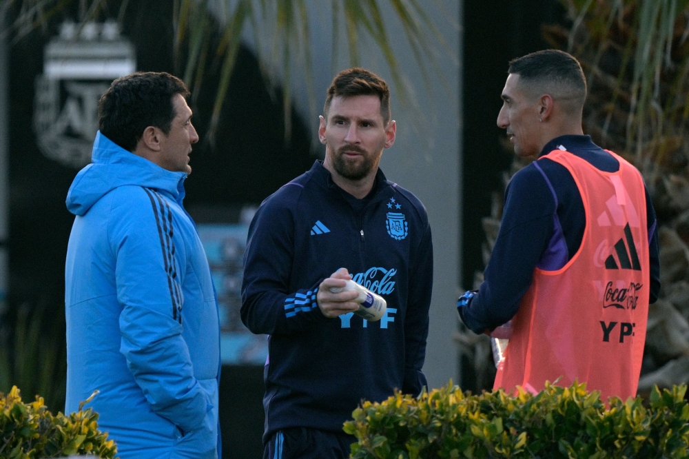 Argentina's forward Lionel Messi (C) and forward Angel Di Maria (R) chat during a training session in Ezeiza, Buenos Aires, on August 5, 2023. (Photo by Juan-Mabromata / AFP)