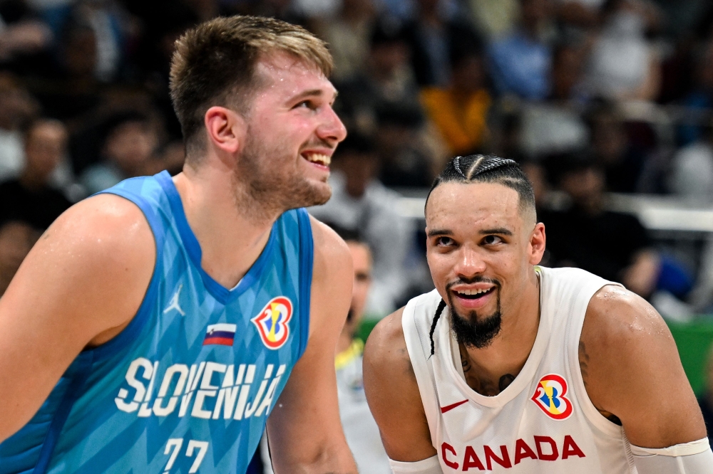 Canada's Dillon Brooks (R) and Slovenia's Luka Doncic react during the FIBA Basketball World Cup quarter-final match between Canada and Slovenia at the Mall of Asia Arena in Manila on September 6, 2023. Photo by SHERWIN VARDELEON / AFP