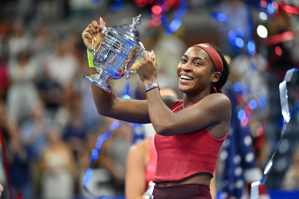 USA's Coco Gauff poses with the trophy after defeating Belarus's Aryna Sabalenka in the US Open tennis tournament women's singles final match at the USTA Billie Jean King National Tennis Center in New York on September 9, 2023. (Photo by ANGELA WEISS / AFP)