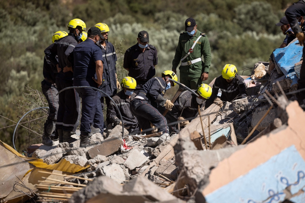 Moroccan rescuers search the rubble for survivors in Talat N'Yacoub village of al-Haouz province in earthquake-hit Morocco on September 11, 2023. (Photo by Fadel Senna / AFP)