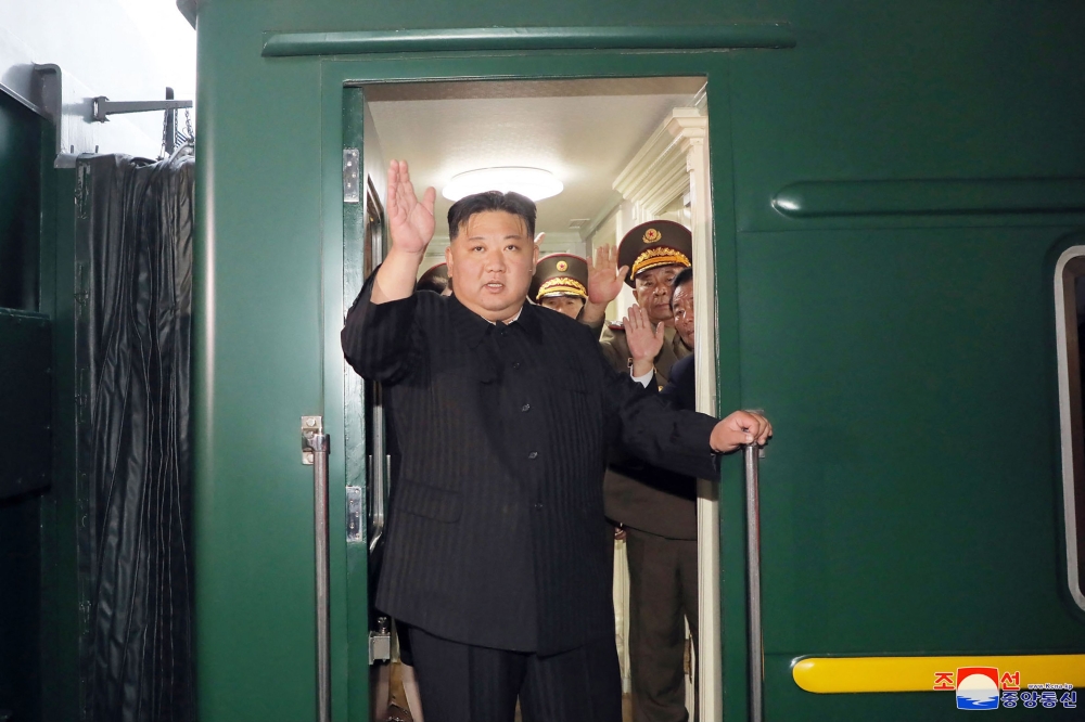 This picture taken on September 10, 2023, and released from North Korea's official Korean Central News Agency (KCNA) on September 12, 2023 shows North Korea's leader Kim Jong Un (C) waving as he departs by train from Pyongyang for a visit to Russia. (Photo by KCNA VIA KNS / AFP)