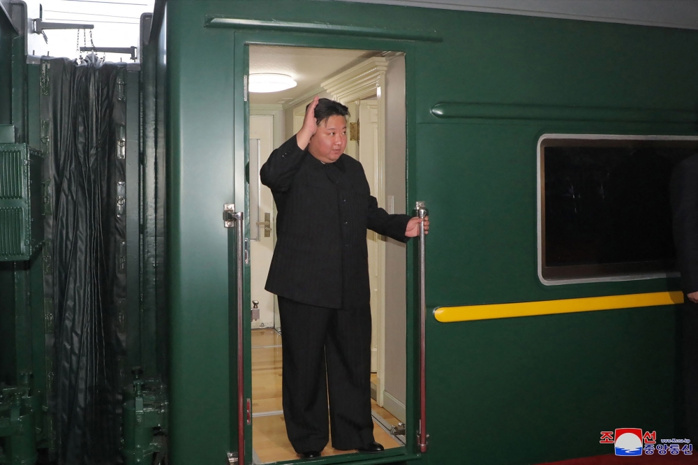 This picture taken on September 10, 2023 and released from North Korea's official Korean Central News Agency (KCNA) on September 12, 2023 shows North Korea's leader Kim Jong Un (C) waving as he departs by train from Pyongyang for a visit to Russia. (Photo by KCNA VIA KNS / AFP) 