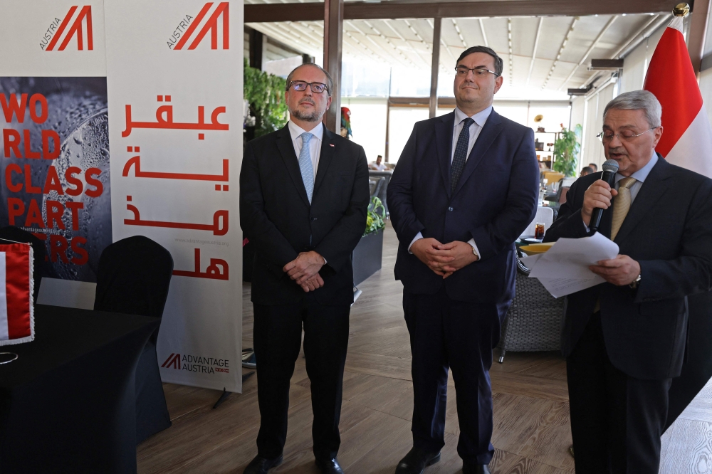 (From left) Austria's Foreign Minister Alexander Schallenberg, Ambassador Andrea Nasi, and Iraq's Foreign Ministry Undersecretary Muhammad Bahr Al-Ulum attend the reopening ceremony of the Austrian embassy in Baghdad on September 12, 2023. (Photo by Ahmad Al-Rubaye / AFP)