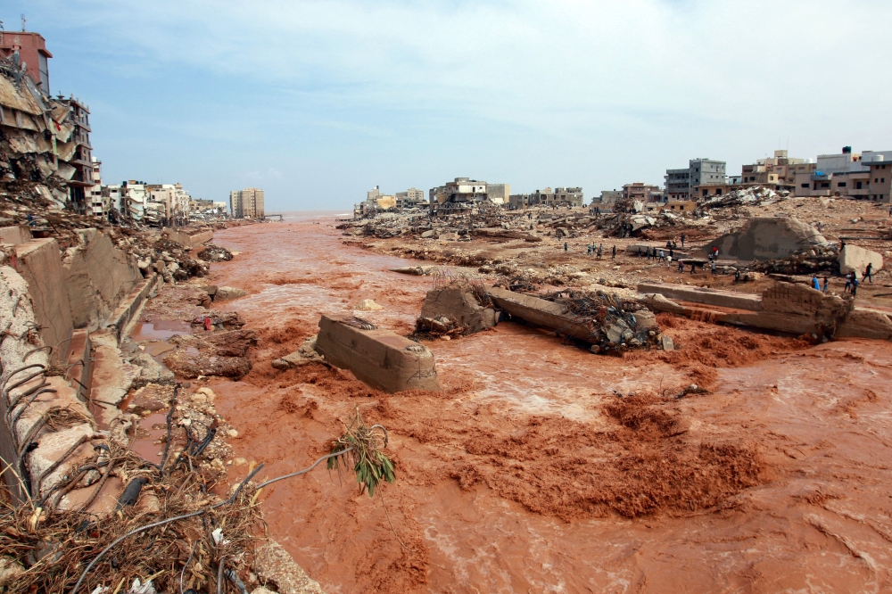 People look at the damage caused by freak floods in Derna, eastern Libya, on September 11, 2023. (Photo by AFP)