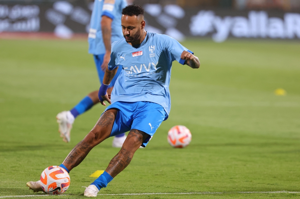 Hilal's Brazilian forward #10 Neymar warms up ahead of the Saudi Pro League football match between Al-Hilal and Al-Riyadh at Prince Faisal Bin Fahd Stadium in Riyadh on September 15, 2023. (Photo by Fayez Nureldine / AFP)