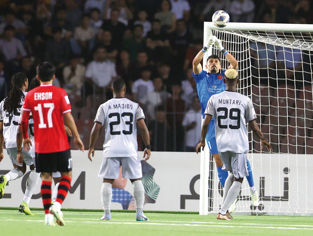 Al Duhail goalkeeper Salah Zakaria makes a save.