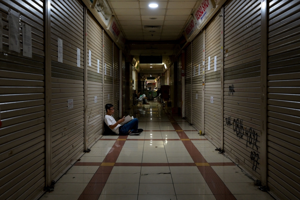 Shops in Southeast Asia's largest textile shopping center are closed and some were even leased and resold at Tanah Abang Market in Jakarta on September 27, 2023. (Photo by Bay Ismoyo / AFP)