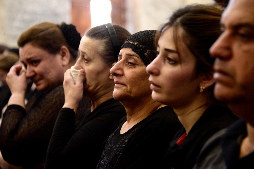 Mourners attend a mass for the victims of the wedding hall fire at a church in Qaraqosh, also known as Hamdaniyah, on September 28, 2023. (Photo by Zaid Al-Obeidi / AFP)