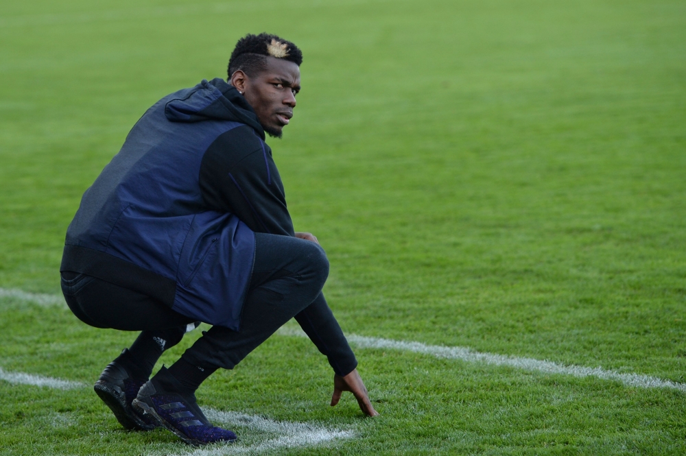 In this photograph taken on December 29, 2019 France national team player Paul Pogba poses on the pitch prior to a football match between All Star France and Guinea at the Vallee du Cher Stadium in Tours, central France, as part of the 
