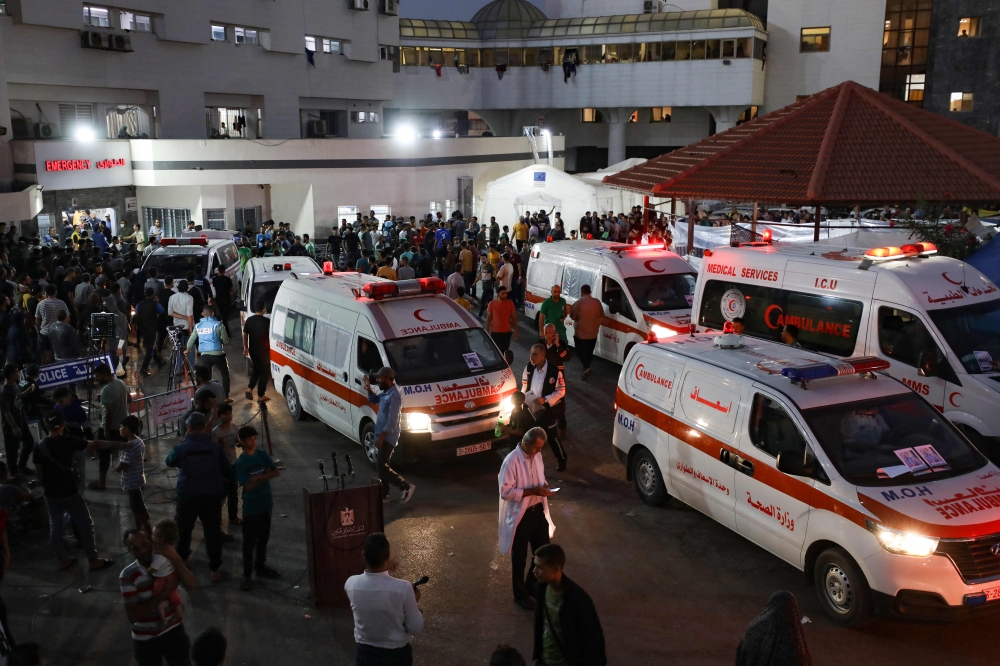 Ambulances carrying victims of Israeli strikes crowd the entrance to the emergency ward of the Al-Shifa hospital in Gaza City on October 15, 2023. Photo by Dawood NEMER / AFP