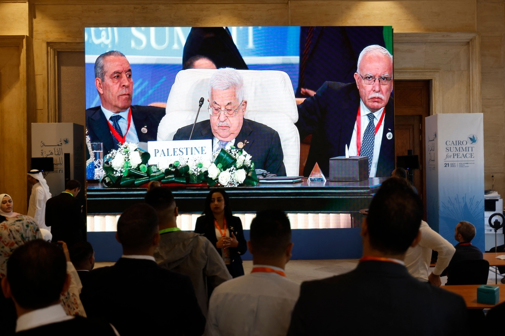 Seen on a large screen the Palestinian president Mahmud Abbas attends the International Peace Summit hosted by the Egyptian president in Cairo on October 21, 2023. (Photo by Khaled Desouki / AFP)