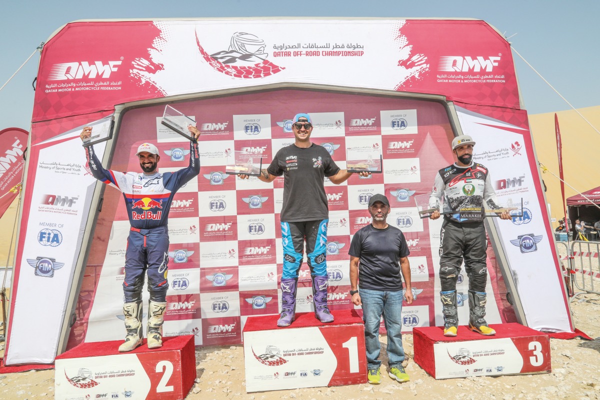 Michael Anderson (centre), Mohammed Al Balooshi (left) and Sultan Al Balooshi (right) celebrate on the podium. 