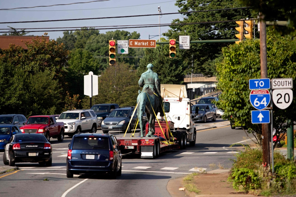 The statue of Confederate General Robert E. Lee is driven away from a park after being removed in Charlottesville, Virginia on July 10, 2021. (Photo by Ryan M. Kelly / AFP)